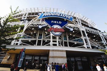 A stadium with a blue and white sign that says Progressive Field.
