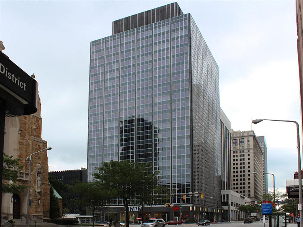 a tall building on the corner of a city street