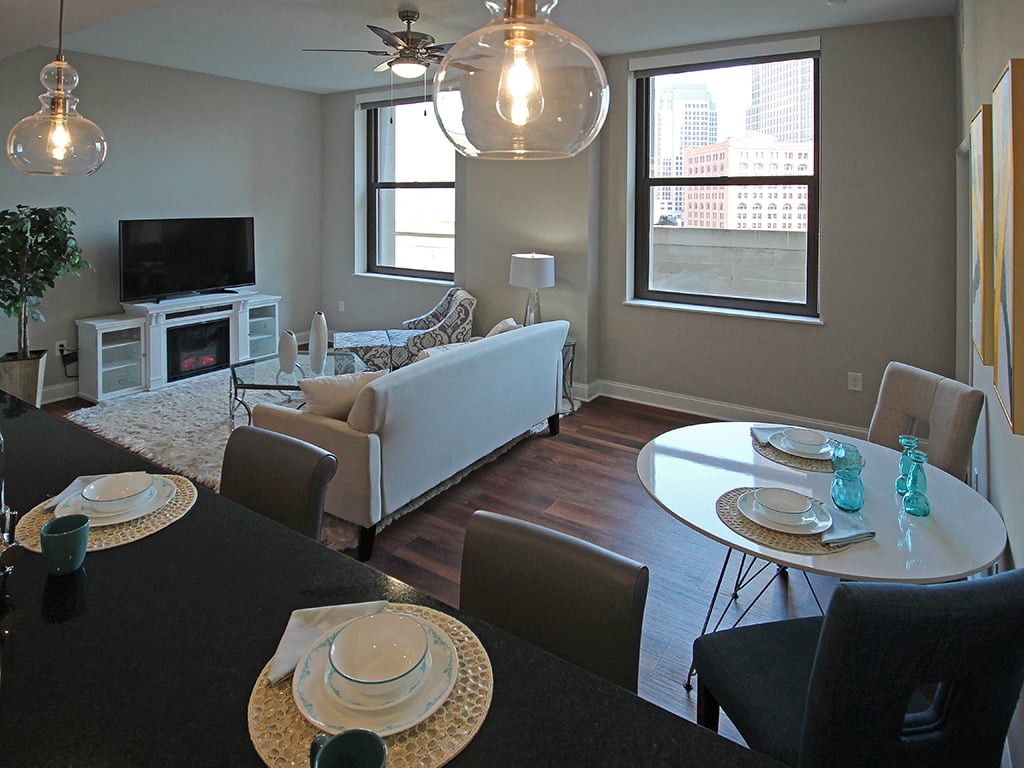 a living room and dining room with a couch and a tv