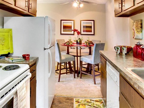 a kitchen and dining room with a table and a refrigerator