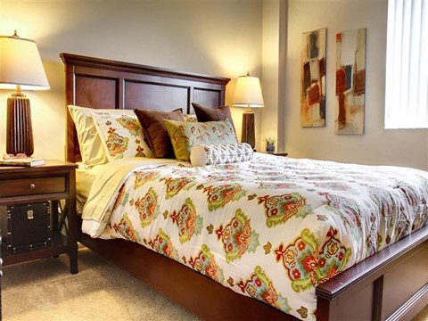 Furnished bedroom with colorful duvet and artwork at Trinity Towers Apartments, Ohio, 44146