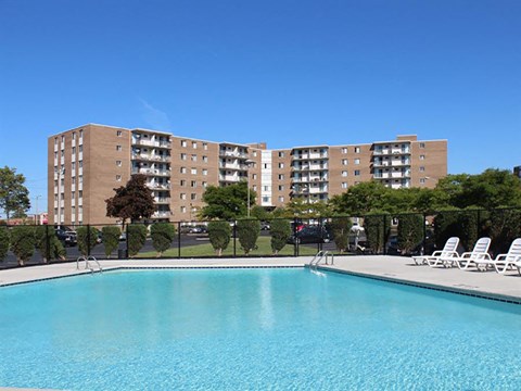 Outdoor swimming pool with lounge chairs at Trinity Towers Apartments, Bedford Heights, OH 44146