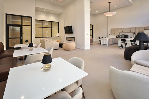 A modern living room with a white dining table and chairs.