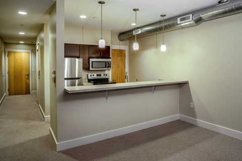 A kitchen area with a microwave, oven, and sink.