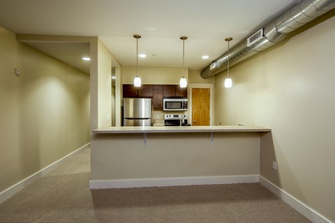 A kitchen area with a counter and a stove.