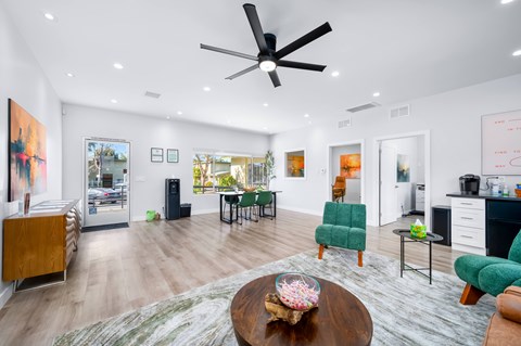 A modern living room with a wooden coffee table and green chairs.