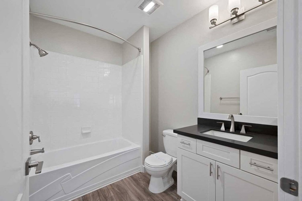 a bathroom with a shower and a sink and a toilet