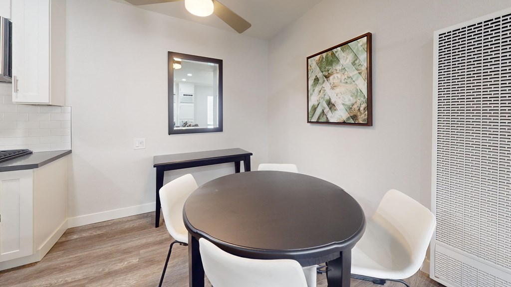 a dining room with a table and chairs and a kitchen