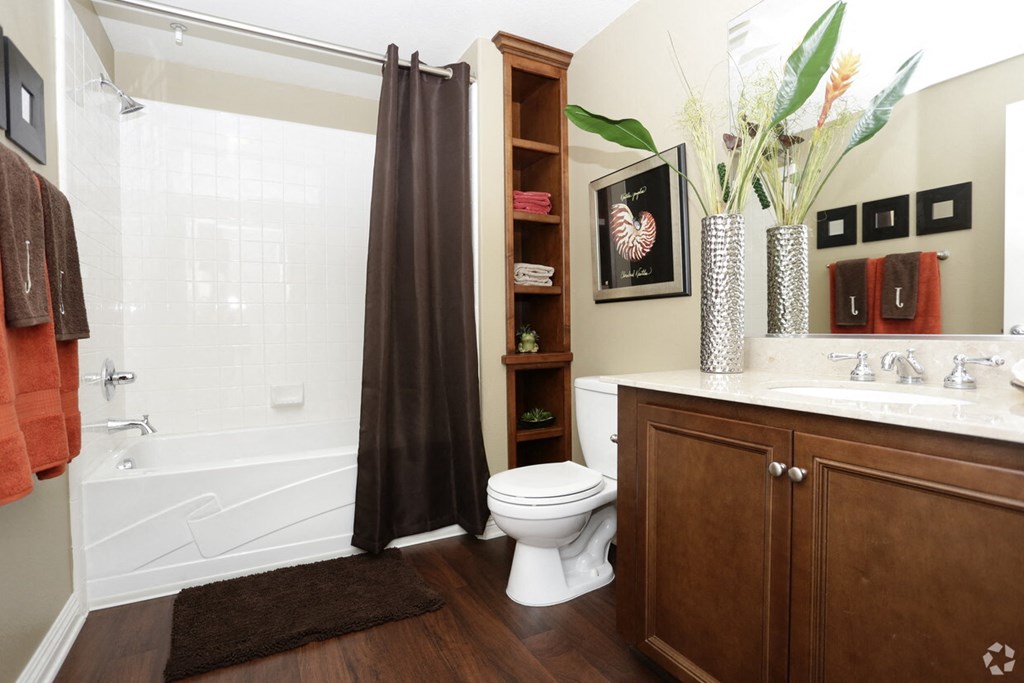a bathroom with a toilet and a shower and a sink
