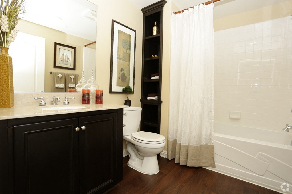 a bathroom with a toilet and a sink and a bath tub