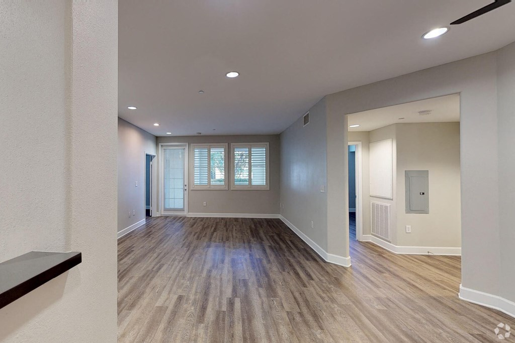 the spacious living room and dining room of a new home