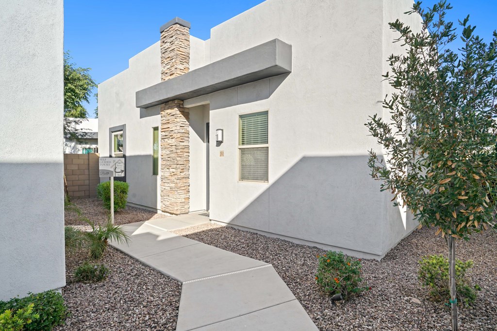 A modern house with a stone pillar entrance.