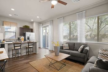 A modern living room with a grey couch and a wooden coffee table.