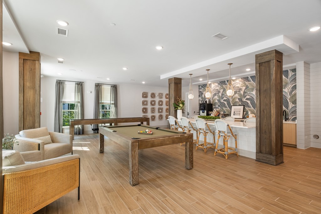 a living room with a pool table and a bar