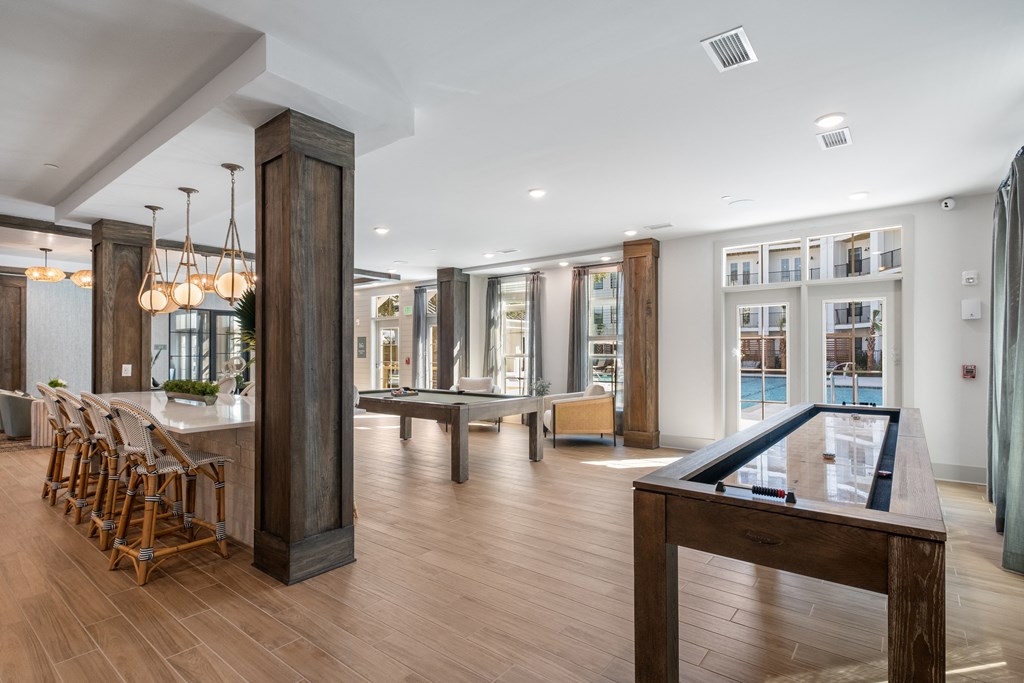 a game room with a pool table and a bar