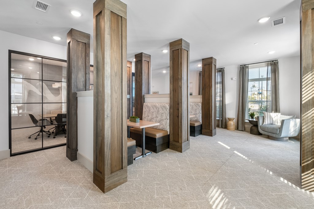 a lobby with wood columns and a table and chairs
