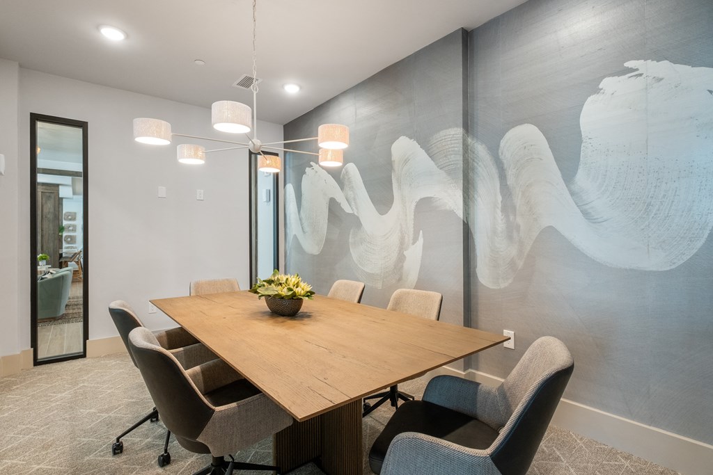 a conference room with a wooden table and chairs