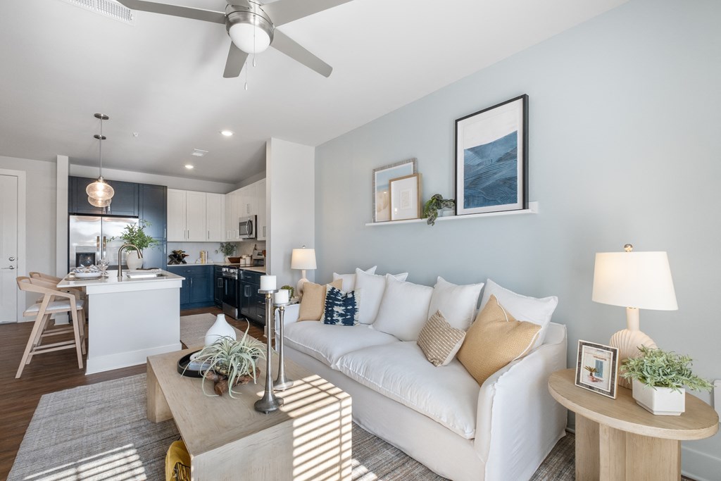 a living room with a white couch and a table