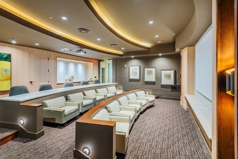 Private Media Room Featuring HD Projector and Theater-Style Seating