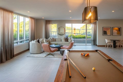 a living room with a pool table and a couch