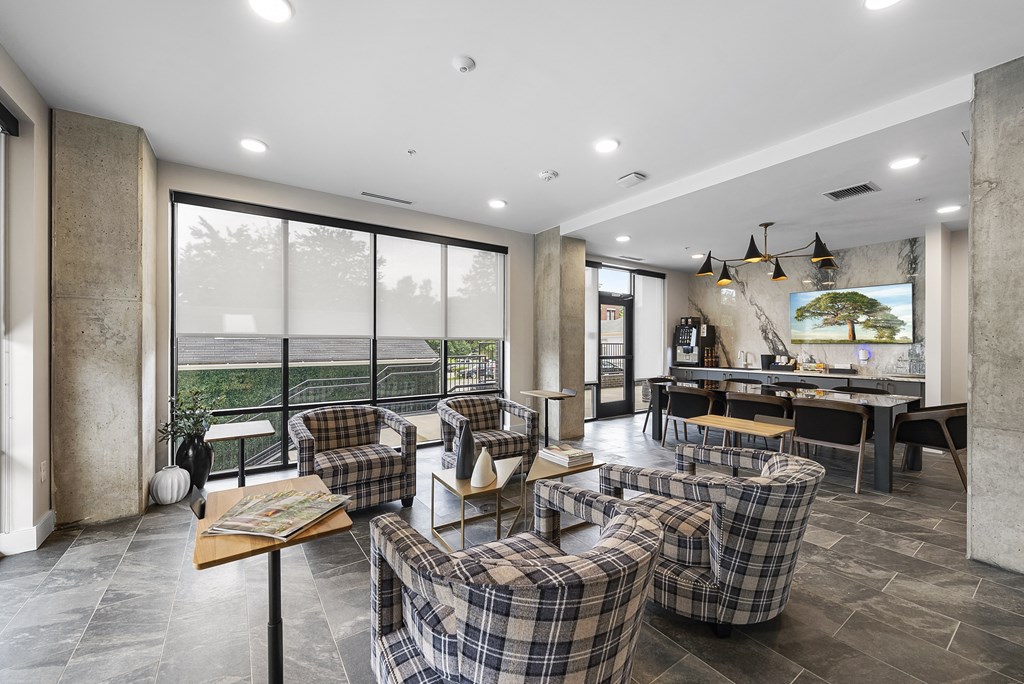 a living room with couches and chairs and a table and a balcony