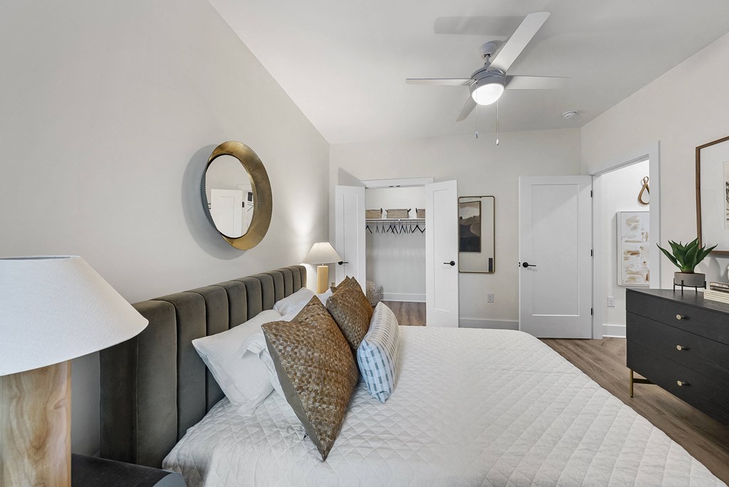 a bedroom with a large bed and a ceiling fan