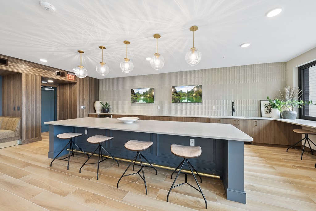 a large kitchen with a blue island and bar stools
