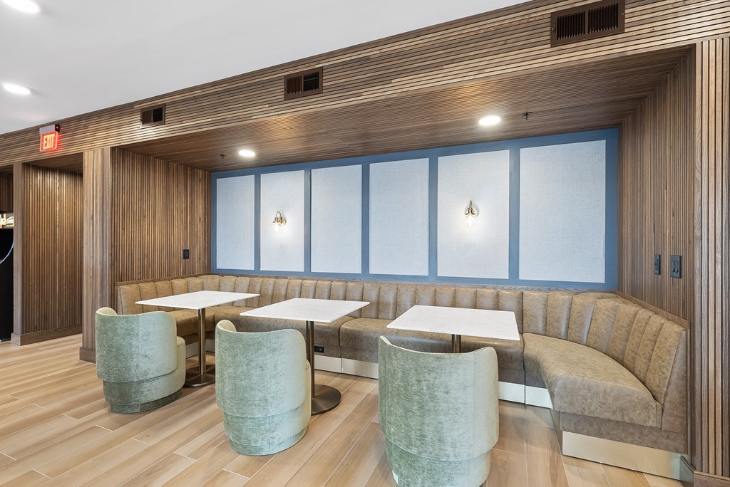 a seating area with a couch and tables and chairs