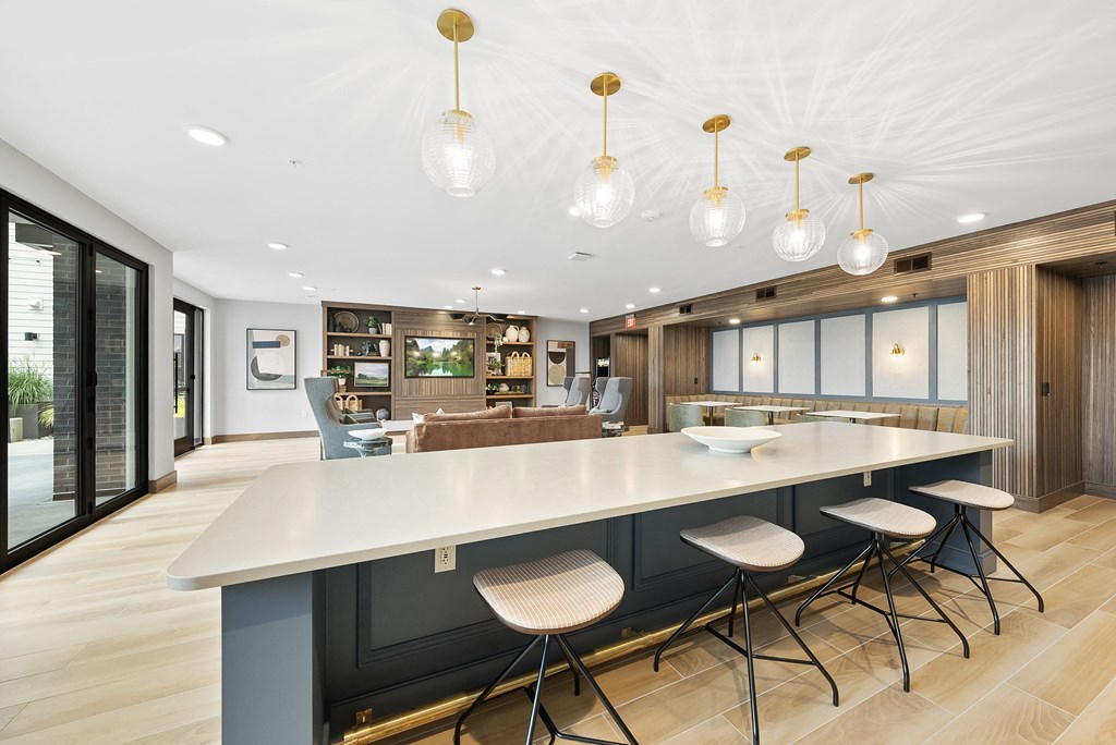 a large kitchen with a large island and chairs