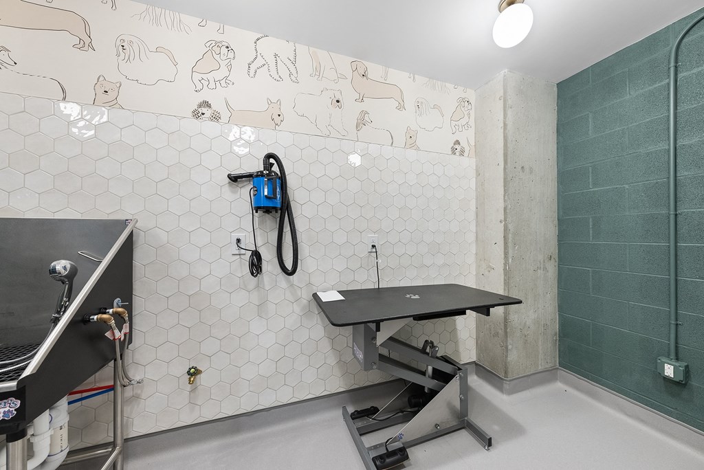 a workout room with a treadmill and a work out station