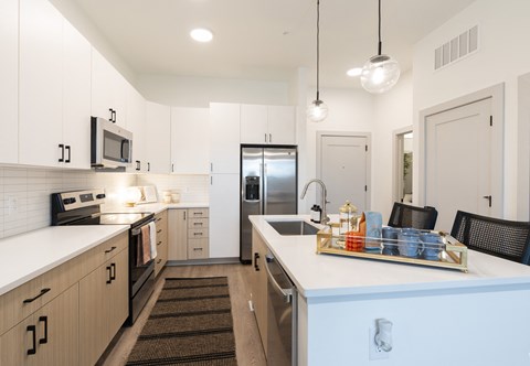 a large kitchen with a counter top and a sink