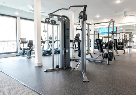 a gym with cardio machines and weights
