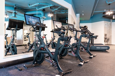 a group of spin bikes in a gym