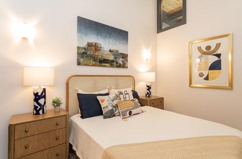 a bedroom with a bed and a painting on the wall
