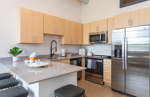a kitchen with stainless steel appliances and an island with a counter top