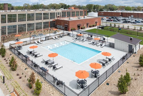 an aerial view of an outdoor pool at a hotel with umbrellas