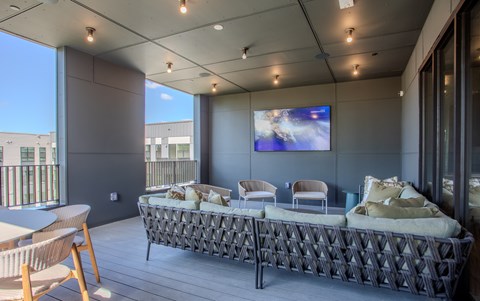 A modern living room with a large sofa and a flat screen TV.
