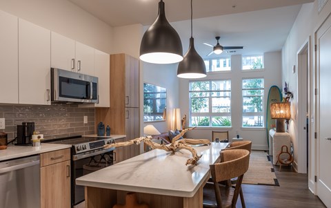 A kitchen with a dining table and chairs.