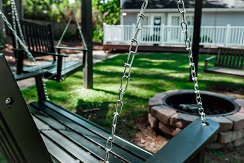 wooden porch swings and fire pit