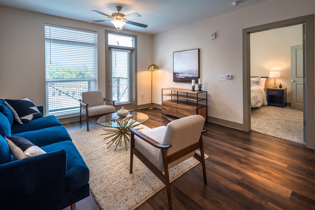 a living room with a couch chairs and a coffee table