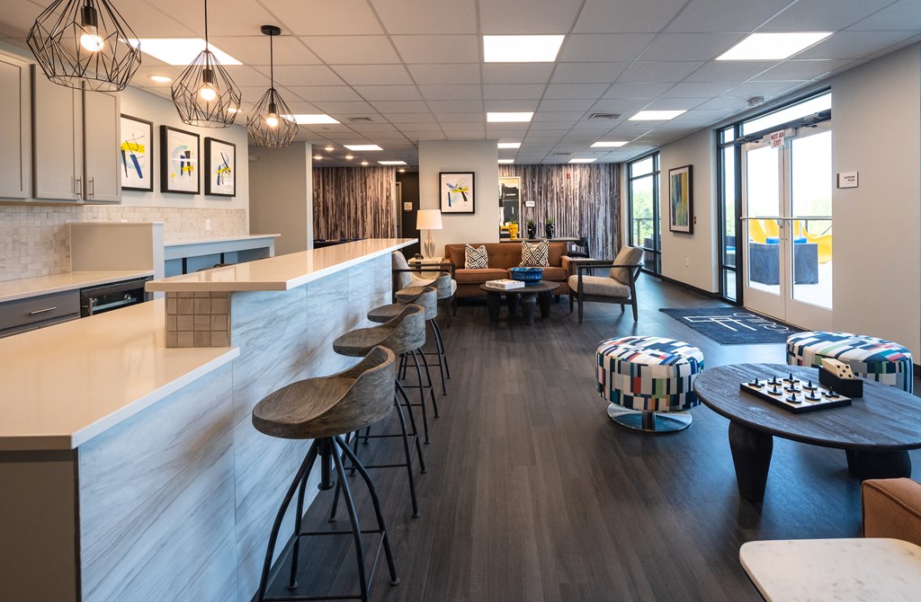 a lounge area with stools and tables