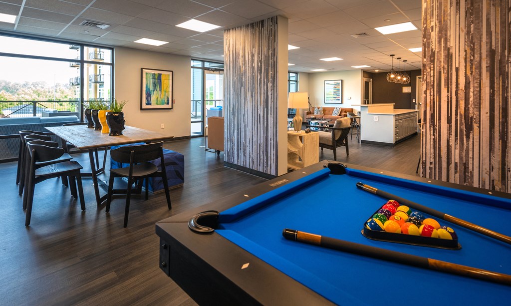 a games room with a pool table and a dining table