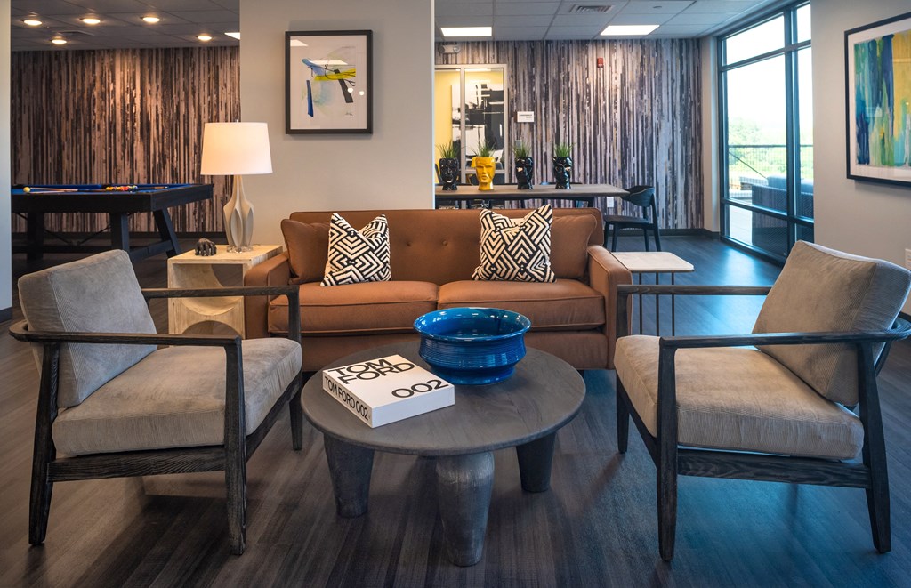 a living room filled with furniture and a large window