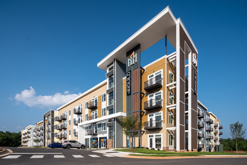a rendering of an apartment building with a blue sky in the background