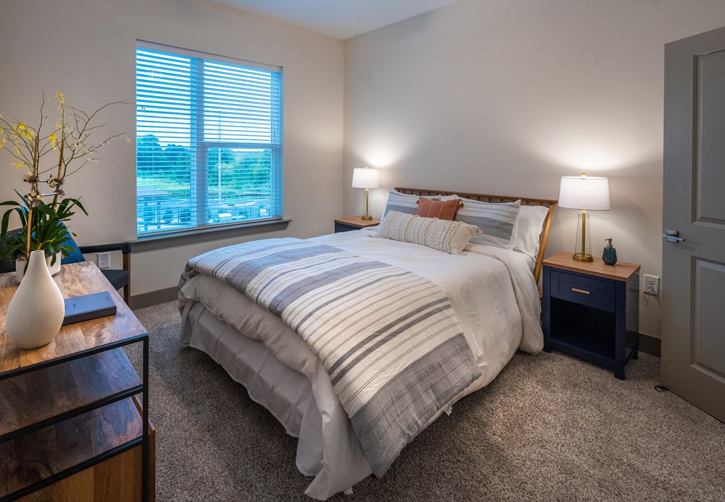 a bedroom with a bed and two night stands