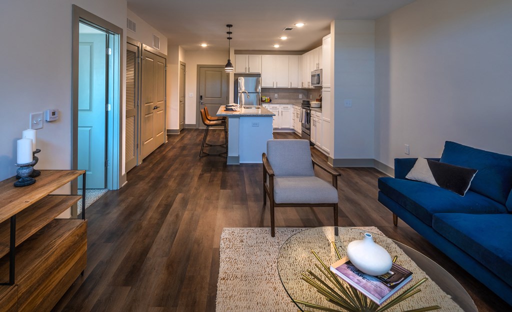 a living room with hardwood floors and a blue couch