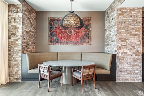 A dining area with a round table and chairs.