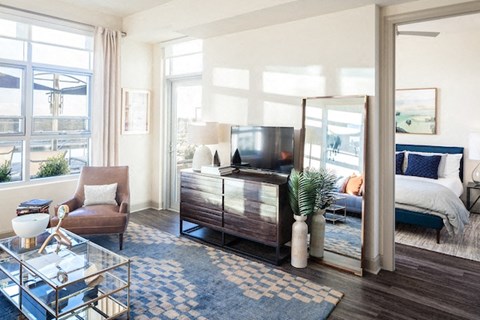 A living room with a brown chair and a glass coffee table.