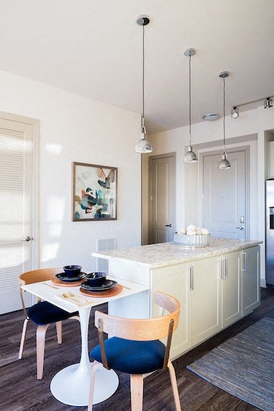 A dining area with a white table and chairs.