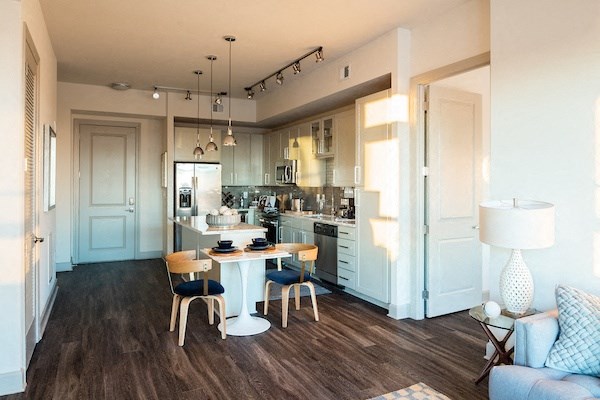 A modern kitchen with a dining table and chairs.